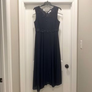 Brand New.  Navy Blue sleeveless dress with a sleeved matching jacket.